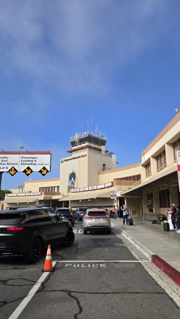 Looking towards a tan building with blue skies behind it.